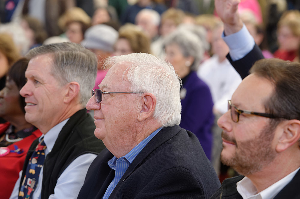 Westbury, New York, USA. January 15, 2017. NYS Senator JOHN E. BROOKS (Dem.- District 8), at center with white hair, along with other local Democratic politicians, sits in the front rows of the "Our First Stand" Rally against Republicans repealing the Affordable Care Act, ACA, taking millions of people off health insurance, making massive cuts to Medicaid, and defunding Planned Parenthood.