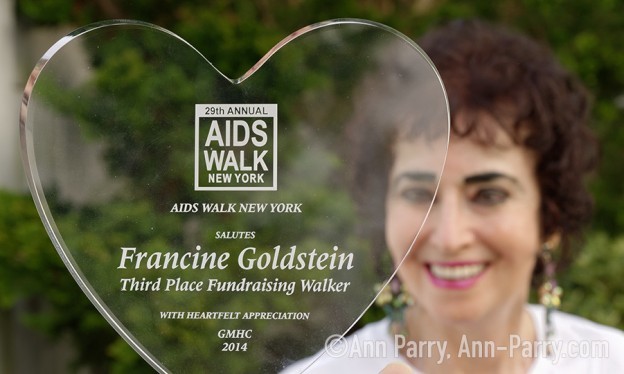 Merrick, New York, USA. May 3, 2018. Francine Goldstein poses with one of many appreciation trophies she's received from AIDS WALK NEW YORK, a fundraising walk and run in Central Park.