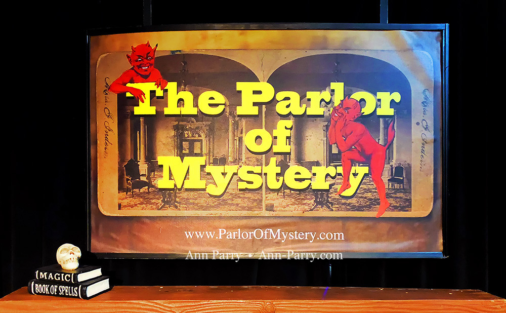 Lindenhurst, New York, USA. September 23, 2018. Closeup of framed The Parlor of Mystery poster handing over mantle, with skull and magic books, on stage set, during Comedy Magic Show presented by The Parlor of Mystery and South Shore Theatre Experience, South Shore Theatre Experience.