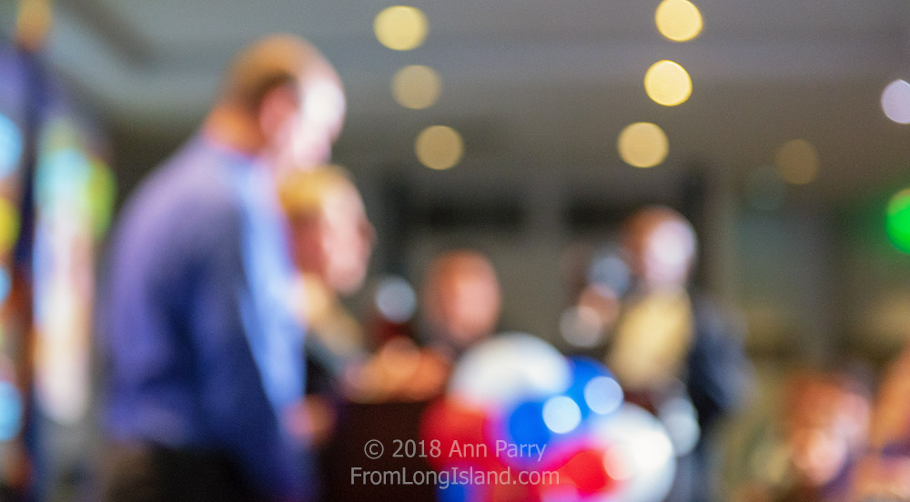Garden City, New York, USA. November 6, 2018. Nassau County Democrats watch Election Day results at Garden City Hotel, Long Island. LIUBA GRECHEN SHIRLEY, candidate for New York Congressional District 2, speaks to supporters after incumbent King is declared winner. CHRISTOPHER SHIRLEY, her husband, joined her onstage. © 2018 Ann Parry, FromLongIsland.com