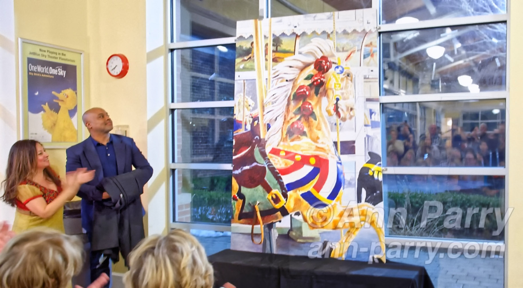 Cayla Kempf rides Nunley's Carousel during Mural Unveiling Celebration, March 9, 2019, in Garden City, Long Island, New York