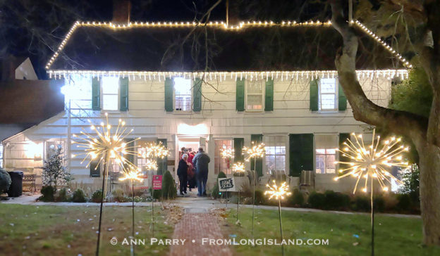 Manhasset, New York, U.S., Dec. 7, 2019. Guests enter historic house, with festive outdoor lights, at Elderfields Preserve during The Art Guild's annual 10x10 Fundraiser Silent Auction and Reception. (© 2019 Ann Parry, AnnParry.com)