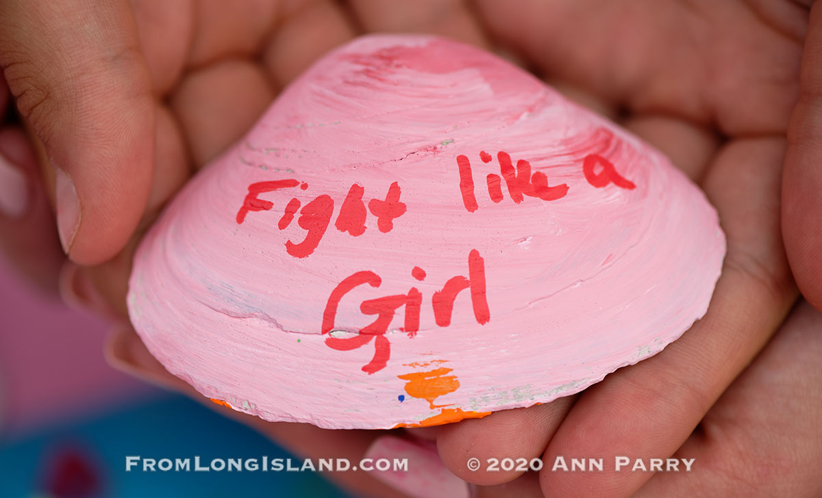 (© 2020 Ann Parry, FromLongIsland.com) Merrick, New York, U.S. August 15, 2020. ANNIE FITZPATRICK, 12-years-old, and friends hold a pink shell with Fight like a Girl written on it. Lizzie's Army painted shells to sell to raise funds to donate to American Cancer Society Making Strides Against Breast Cancer. Annie's 24 year old sister Lizzie was diagnosed with Triple Negative Breast Cancer in late June . Over $3,000 has been raised so far through shell sales and GoFundMe.