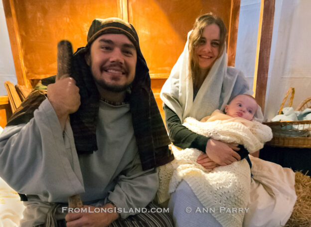 Garden City, New York, USA. December 6, 2013. Visitors experience the nativity scene at the manger, with Mary, Joseph, and baby Jesus, the Holy Family, at A Night in Bethlehem, an annual Advent at the Lutheran Church of the Resurrection, on Long Island, on December 6, 7, and 8.