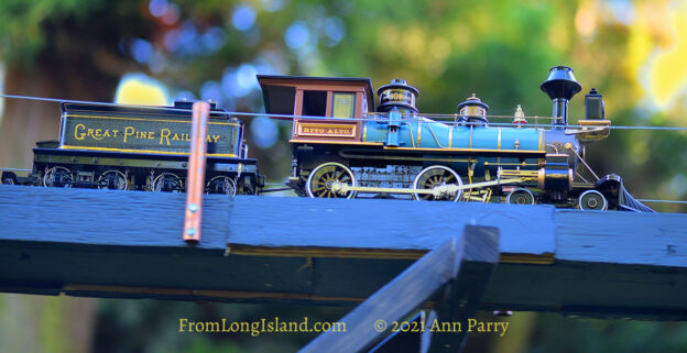 Old Westbury, New York, U.S. June 23, 2021. Long Island Railroad model trains, a large G gauge, travel outdoors during the Old Westbury Gardens opening reception for its Great Pine Railway exhibit, which includes Long Island landmarks and runs until September 6. (© 2021 Ann Parry, FromLongIsland.com)