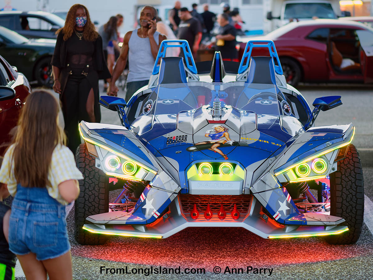 Bellmore, NY, U.S. July 30, 2021. A Polaris Slingshot, a three-wheel autocar, is colorfully lit at the Bellmore Friday Night Car Show, held at the Bellmore Long Island Rail Road parking lot. (© 2021 Ann Parry/AnnParry.com)