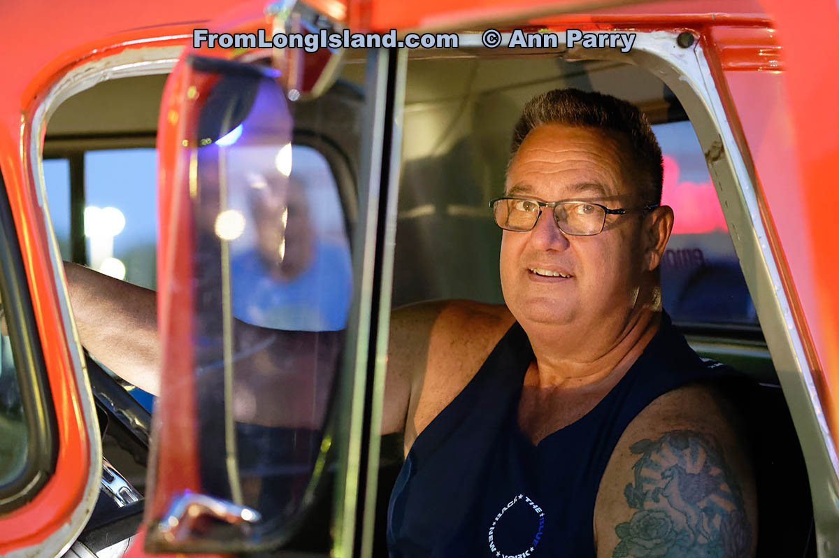 Bellmore, NY, U.S. July 30, 2021. RUSS KOHLER of Seaford is sitting in driver's seat of his orange 1959 Chevrolet 3100 Apache truck at the Bellmore Friday Night Car Show. (© 2021 Ann Parry, AnnParry.com)