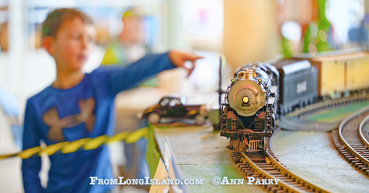Dec. 26, 2022. Garden City, N.Y., U.S. A boy points to one of the model trains traveling on the Long Island Garden Railway Society display in the atrium of the Cradle of Aviation Museum.