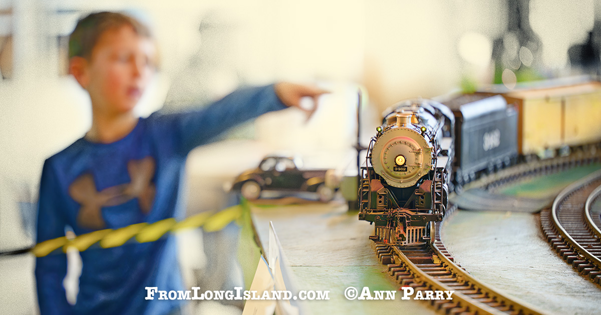 Dec. 26, 2022. Garden City, N.Y., U.S. A boy points to one of the model trains traveling on the Long Island Garden Railway Society display in the atrium of the Cradle of Aviation Museum.